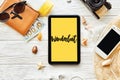 Wanderlust text sign. travel concept text on yellow tablet scre