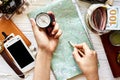 Wanderlust and travel concept flat lay. hand holding compass and Royalty Free Stock Photo