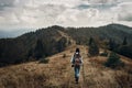 wanderlust and travel concept with space for text. hipster traveler on top of mountains, amazing view. stylish woman hiking. atm