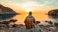 Wanderlust travel, tourist with backpack sitting near the sea, man enjoying sunset, solo traveler backpacker. Royalty Free Stock Photo