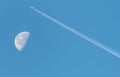 Waning Gibbous Moon near last quarter, daytime shot with an aeroplane over the moon. Royalty Free Stock Photo