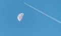 Waning Gibbous Moon near last quarter, daytime shot with an aeroplane over the moon. Royalty Free Stock Photo