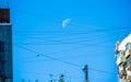 Waning moon caught on the wires
