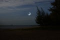 Waning moon over the sea in early morning Royalty Free Stock Photo