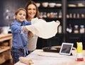 Wanna stay for dinner Were making pizza. Portrait of a mother and daughter holding up the pizza dough they made. Royalty Free Stock Photo