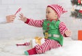 Cute Baby Elf Reaching Hand For Christmas Lollipop