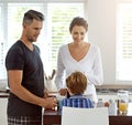 We want to see where that breakfast goes. parents watching their son as he eats his breakfast.