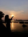 She want try touch sunset but cannot touch just look good visual picture Royalty Free Stock Photo