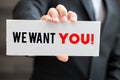 We want you, message on blackboard and hold by businessman