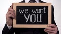 We want you phrase on blackboard in businessman hands, promising job offer