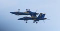 Two Navy blue angel jets one upside down over the other Royalty Free Stock Photo