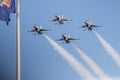 Four F-16 usaf Thunderbirds flying in the diamond formation passing a flag Royalty Free Stock Photo