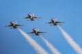 Four USAF Thunderbirds F-16 jets flying in the diamond formation with a blue sky Royalty Free Stock Photo
