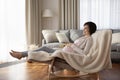 Peaceful young woman expecting mother recline on comfy rocking chair