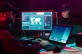 Wanted hackers coding virus ransomware using laptops and computers in the basement. Cyber attack, system breaking and