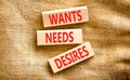 Wants needs and desires symbol. Concept words Wants Needs Desires on wooden blocks. Beautiful canvas table canvas background.