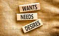 Wants needs and desires symbol. Concept words Wants Needs Desires on wooden blocks. Beautiful canvas table canvas background.