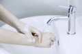 Waoman hands washing or cleansing with soap foam under tap water at lavatory. Concept good hygine and coronavirus protection