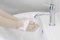 Waoman hands washing or cleansing with soap foam under tap water at lavatory. Concept good hygine and coronavirus protection