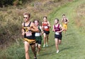 Boys running 5K race on a downhill on a grass field Royalty Free Stock Photo