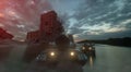 War Concept. Group of Heavy Military Tanks Moving through street of destroyed city at sunset. 3d rendering