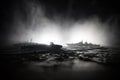 Silhouettes of a crowd standing at blurred military war ship on foggy background. Selective focus. Passengers try to escape.