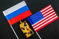 War, confrontation concept. Russia, USA. Tanks toy near russian and american flag on black background top view Royalty Free Stock Photo