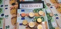 War finance. A calculator surrounded by euro bills and coins. The concept of militarization, increased spending on weapons Royalty Free Stock Photo