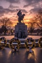 war memorial with wreaths and candles at dusk