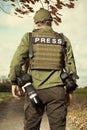 War photographer in conflict zone preparing for job