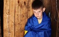 war russia against Ukraine. crying Ukrainian boy with the flag of Ukraine outdoors. Stop war. anti-war protest, cry