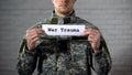 War trauma words written on sign in hands of male soldier, mental disorder