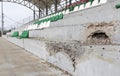 War in Ukraine. Broken plastic benches for fans on the podium, in a destroyed football stadium in a children's