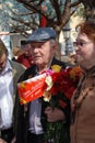 A war veteran holding flowers.