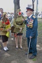 War veteran man portrait. He receives flowers from young women