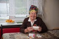 War veteran old woman sits at a table and examines medicine boxes