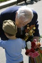 War veteran receives flowers from a boy.