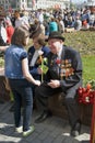 War veteran receives flowers from a girl.