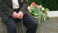 War veteran with stick sitting alone outdoors. Royalty Free Stock Photo