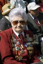 War veteran woman portrait. Her jacket is decorated by many medals.