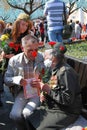 A war veteran woman receives flowers from other people