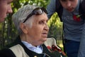 A war veteran woman talks to young generation about the war.