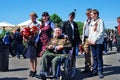 War veteran and young people pose for photos.