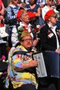 War veterans sing songs. A woman plays accordion.