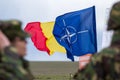 War zone. NATO flag in extension with romanian flag.