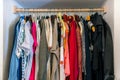 Wardrobe full of different color, material and texture clothes,