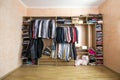 Wardrobe full of different men and woman clothes