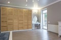 Wardrobe made of thin wooden planks in apartment room. ecological furniture