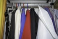 Wardrobe overflowing and colorfully mixed with jackets and pants, sweaters Royalty Free Stock Photo