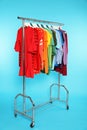 Wardrobe rack with different bright clothes Royalty Free Stock Photo